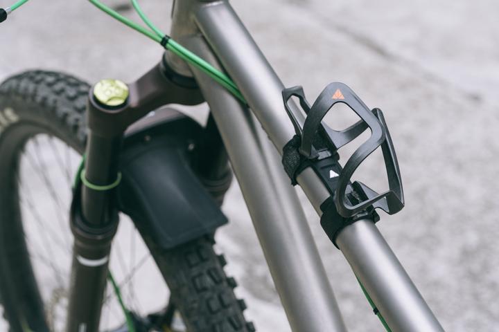 Actual product image Granite Aux, carbon bottle cage with straps, holders with side opening, fits up to 70mm Diameter