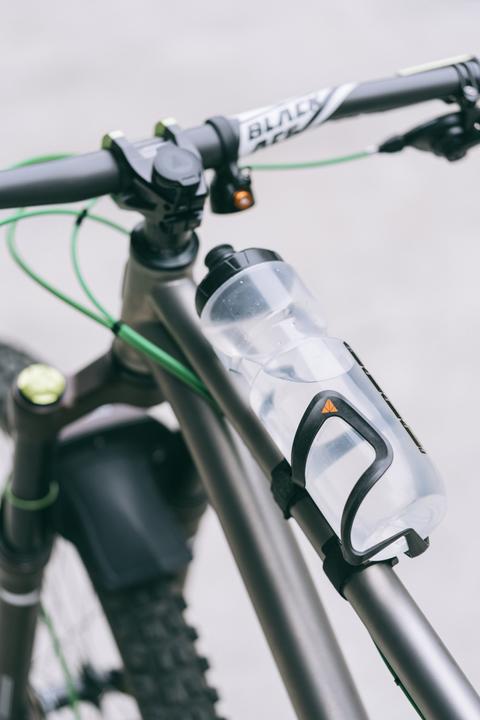 Actual product image Granite Aux, carbon bottle cage with straps, holders with side opening, fits up to 70mm Diameter